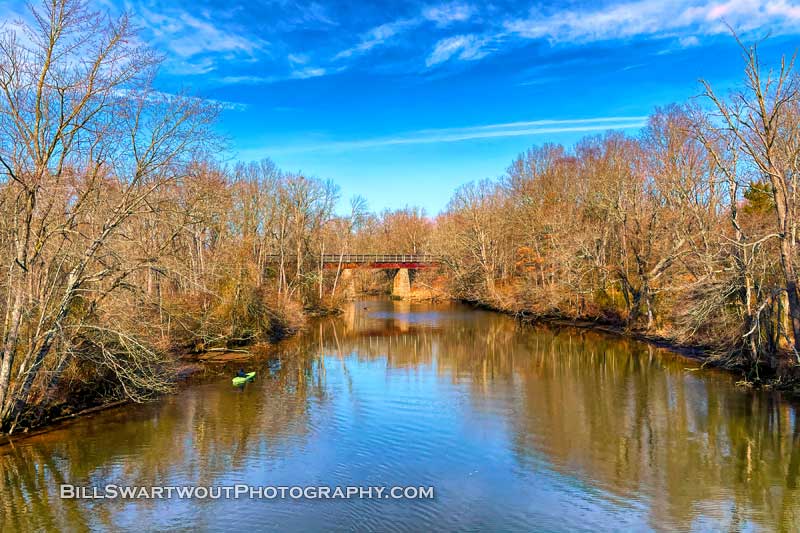 A kayaker on the Tuckahoe River near the old railroad bridge.